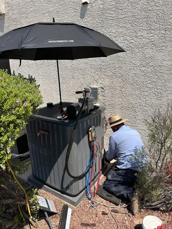 HVAC technician performing outdoor AC maintenance in Pacifica