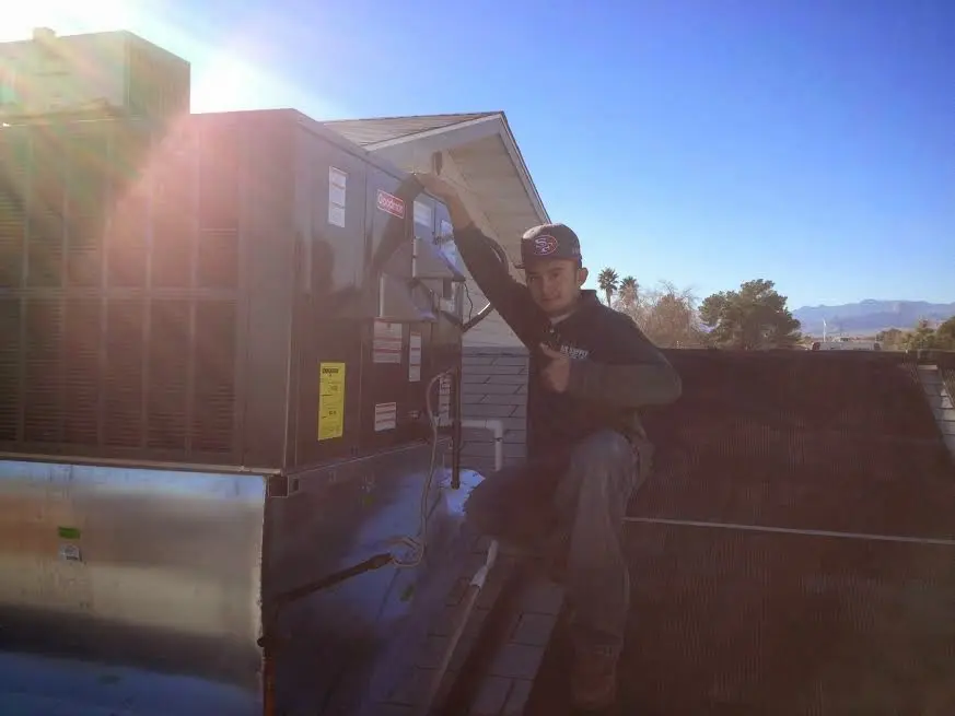 HVAC technician performing Air Duct Repair on a rooftop unit in Pacifica